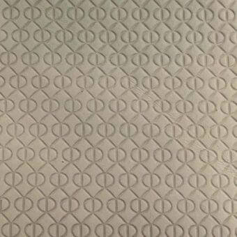Printed leather rugiano rug with repeating gray diamond pattern featuring raised circular and linear elements in a grid layout.